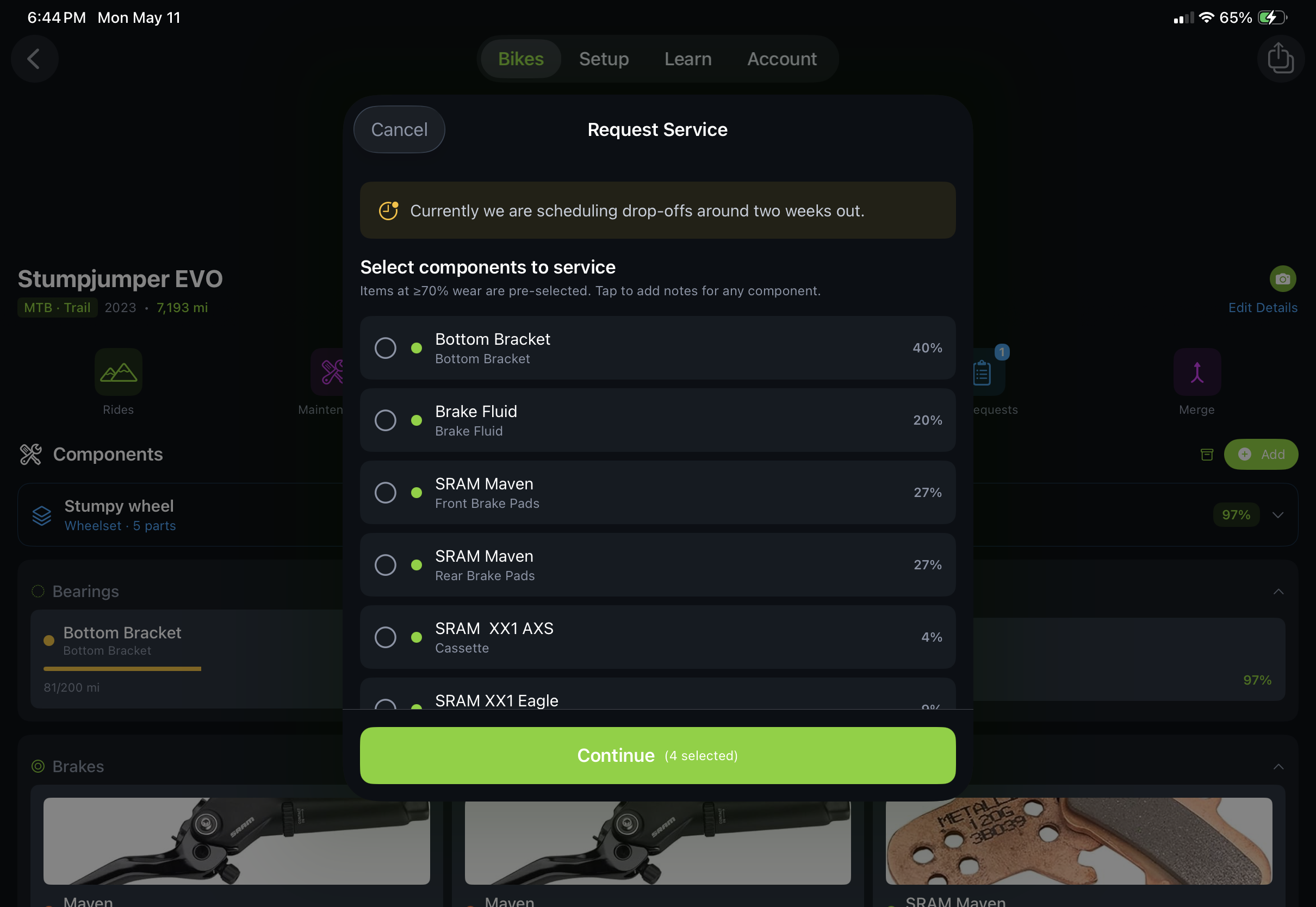 Trail Hits service request submission flow on iPad — customer picks their bike, picks a drop-off slot from the shop's available dates, and reviews pre-selected worn components before submitting